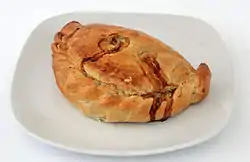 A light brown pastry case is on a white plate