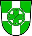 a cross nowy - Vert; a cross nowy, argent, charged with four hearts their points conjoined, within an annulet, vert - City of Chilliwack, Canada