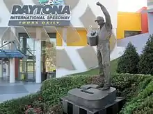 Statue of Dale Earnhardt Sr. holding his winner's trophy