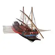 Model of a large galley with a blue hull and red decking