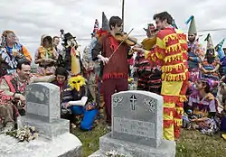 Savoy (red and yellow costume) playing at the grave of Dennis McGee, at the 2009 Faquetigue Courir