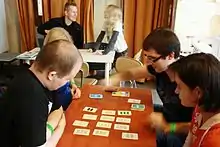 A group of people at a table playing set