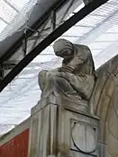 View of the crouching figure at the top left of the memorial wall.