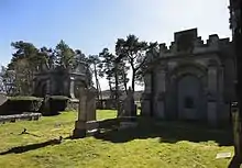 Mausoleum adjacent to the church (right) and second Mausoleum outside the churchyard (left)