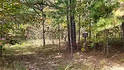 A forest service sign at the site of Enough