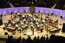 A musical ensemble receives applause at the end of a concert.