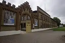 Brick factory building with metal gate