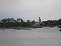 The Morocco pavilion as seen from across World Showcase Lagoon; The Twilight Zone Tower of Terror, whose top is designed to blend in with the pavilion, can be seen beyond the treetops.