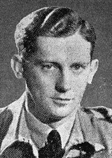 A head and shoulders photograph of a clean shaven man in uniform