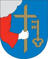 Hand holding Christian cross in the coat of arms of Pärnu