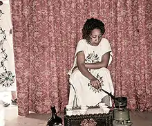 Image 1Ethiopian woman wearing a traditional Habesha kemis dress, preparing coffee using a Jebena (from Culture of Ethiopia)