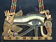 Eye of Horus pectoral.hieroglyphs: Red crown, White crown, Shen ring, uraeus, mut vulture, Eye of Horus