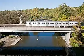 A T1 crosses the bridge over the Humber River on its way west to Old Mill station