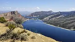 Wide river with sloped landscape on both sides,