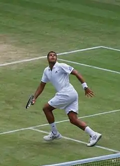 Tsonga running backwards looking to hit an overhead.