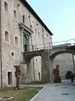 The main gateway was protected by a bridge. The rock-cut dry moat now has art installations.