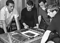 Flórián Albert, Lajos Szűcs, and Zoltán Varga discussing the plans of the new stadium in 1968