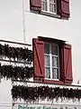 Traditional Espelette house with peppers drying on the walls