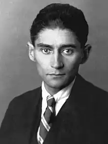 Black-and-white photograph of Kafka as a young man with dark hair in a formal suit