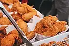 Fried chicken, a southern dish consisting of chicken pieces that have been coated with seasoned flour or batter and deep fried