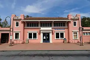 A two-story pink railroad station building