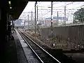 View from Nambu Line platform 1 with the Musashino Line stabling sidings visible above, July 2006