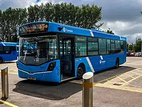 A two-tone blue single deck bus parked at a bus stop.