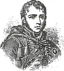 Black and white print of a man with curly hair and very long sideburns. He wears a hussar uniform of the Napoleonic era (1800-1815).