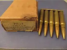 five cartridges held together at their bases by a strip of metal