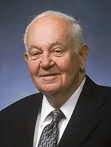 Portrait of an older Glen P. Robinson. He is wearing a suit and a tie.