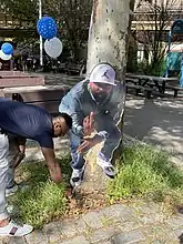 Homemade memorial in Brooklyn, NYC featuring a photo cut-out of the deceased giving the middle-finger