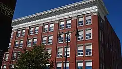 Exterior of building red bricks with white trim around windows constructed in Edwardian architecture