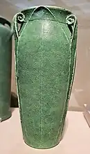 Green, glazed ceramic vase with small handles.