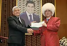 Japanese Prime Minister Shinzo Abe (right) wearing a papakha next to rector of the Magtymguly Turkmen State University Gurtnyyaz Nurlyyewic Hanmyradow (left)