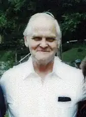 A man's face in front of a green background