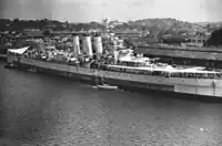 HMS Sussex docked in Singapore on 12 September 1945