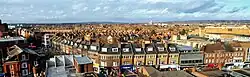 Partial Panorama looking northwest towards Pinner (left) and Headstone (right) from building at the bottom of the northern downslope of Harrow on the Hill (200m north of the mainline station) - the listed building on the left in the foreground is 315 Station Road, Harrow,  closest to the hill itself, currently occupied by NatWest