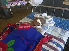 image of an old person lying on a bed in Iganga hospital in Uganda