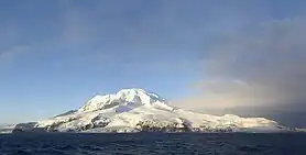 A view of the snow-capped Heard Island from a boat.