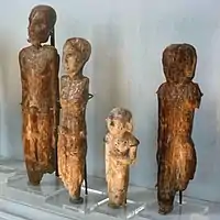 Male statuettes with penile sheaths.