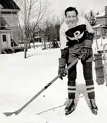 Ranscombe posing in uniform holding a hockey stick