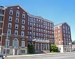 Front view of hotel, a tall brick building with two projecting wings