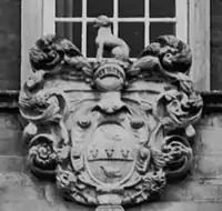 Arms above front door.