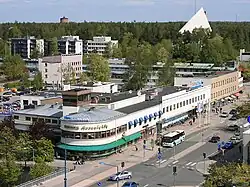 Ahjo building from 1935 in central Hyvinkää. The church of Hyvinkää in the background.