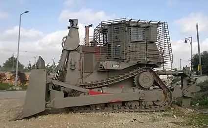 IDF D9T (4th generation armor) parking near a military outpost (left-side view)