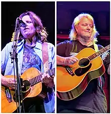 Indigo Girls strumming guitars onstage