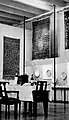 "Jewish Year": Passover; seder table with centerpiece of painted blech (sheet metal); in the display cases, numerous seder plates, with scriptural rugs above.