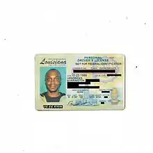 Photo of a Louisiana diver's licence, licence photo features JPEGMAFIA smiling. The personally identifying information on the licence is blocked out by black bars and a text in a pixel-like font displays the word "veteran" under the licence photo.