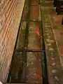 Foundations of the older churches, seen through glass in the floor