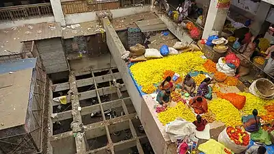 Flower-garland makers working on the intermediate level of one of the central lighting pits (4 in all)